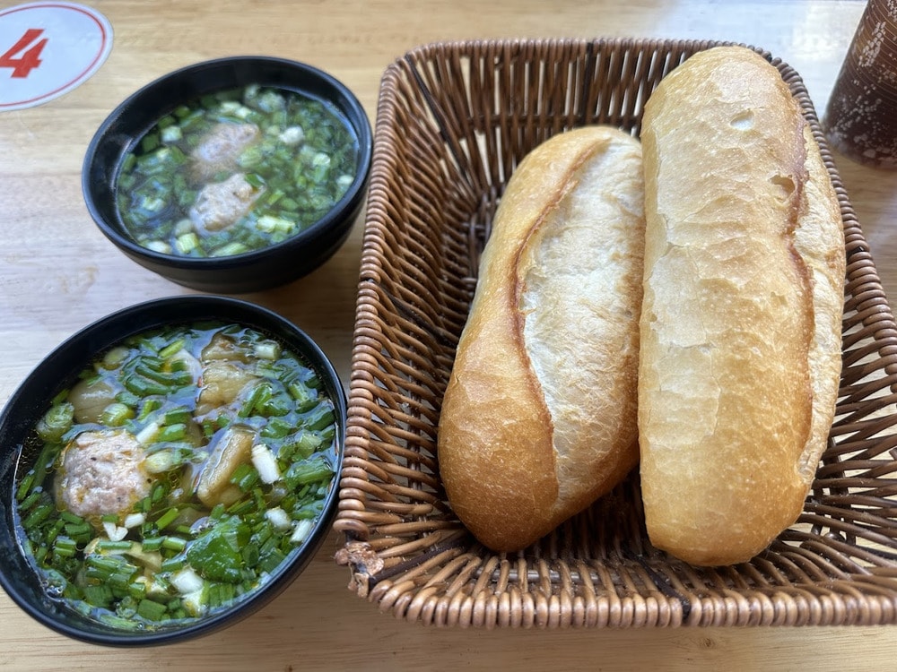 Một suất bánh mì xíu mại gồm chiếc bánh mì nướng giòn và bát xíu mại đậm vị 